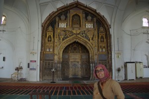 Dani, brav mit Kopftuch vor dem Mihrab, der Gebetsnische, dem Allerheiligsten der Moschee